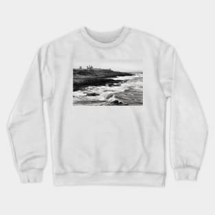 Rough waves hit the rocks near Dunstanburgh castle in Northumberland, UK Crewneck Sweatshirt